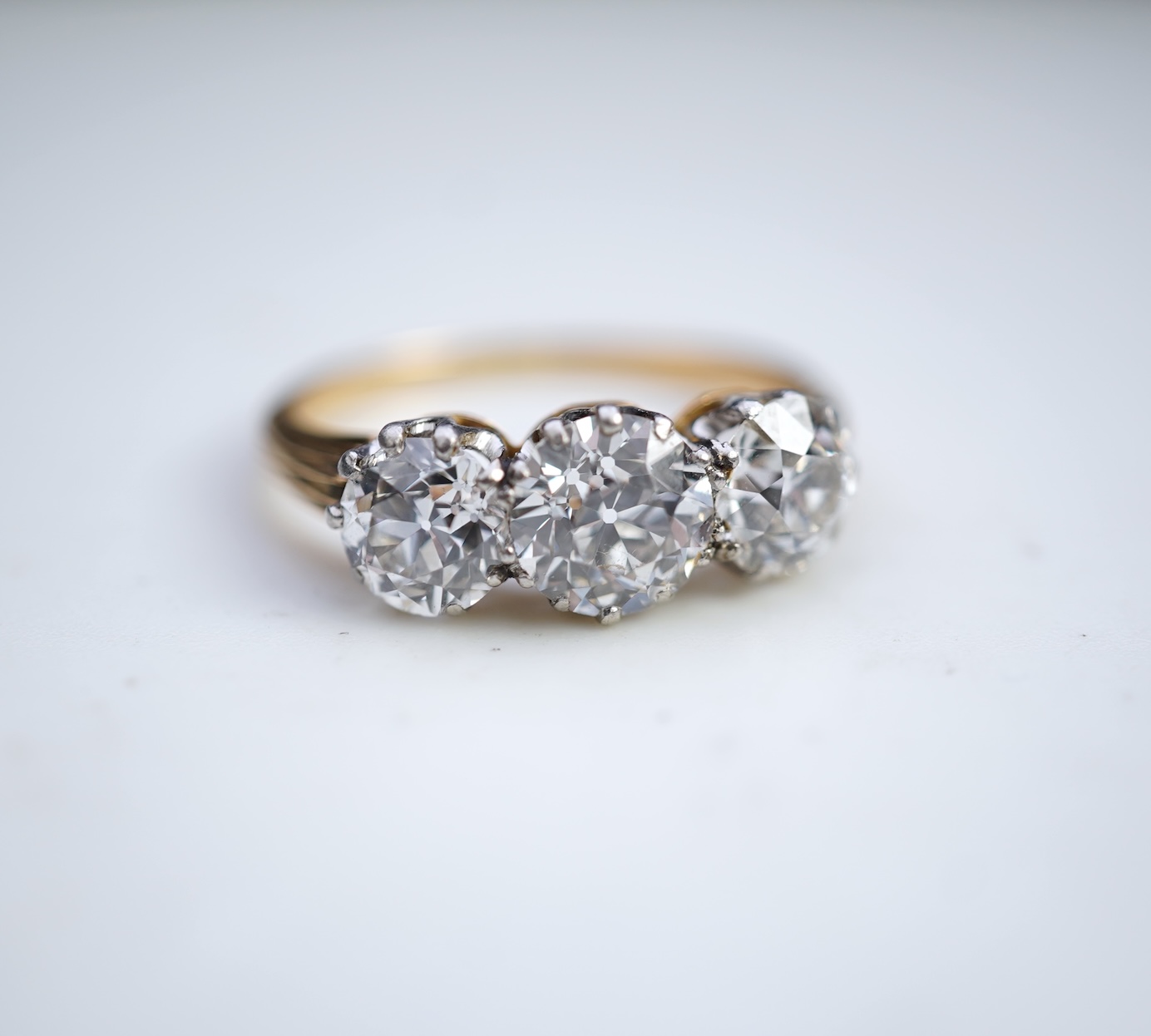 An attractive three-stone diamond ring, early 20th century